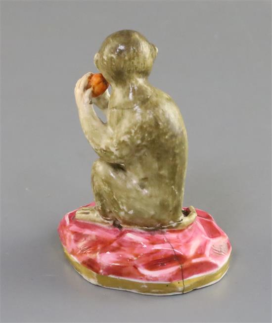 A Rockingham porcelain figure of a seated monkey, c.1830, H. 7.1cm, repaired